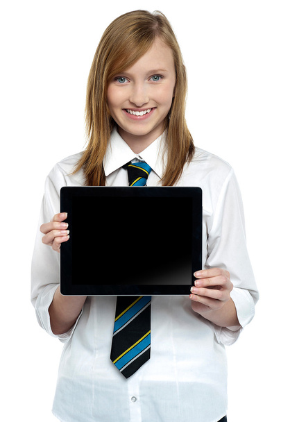 Pretty college girl displaying a tablet device - 写真・画像