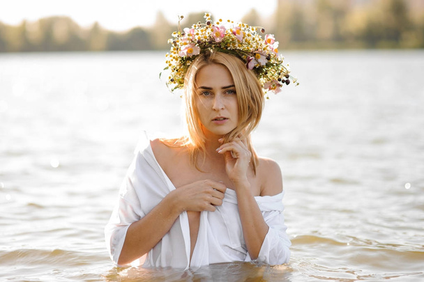 Nude portrait of the attractive blond woman in flower wreath - Photo, Image