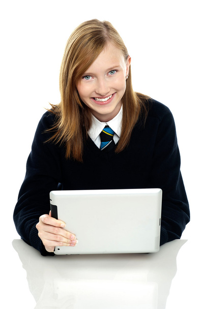 Pretty schoolgirl holding newly launched tablet pc - Fotoğraf, Görsel