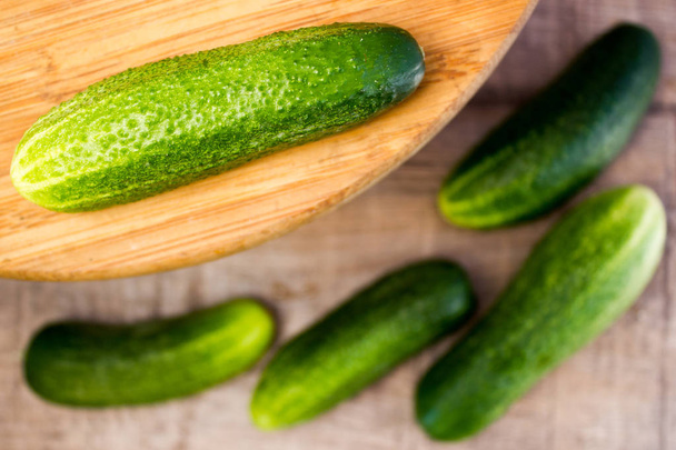 Fresh cucumbers on wooden - Фото, изображение