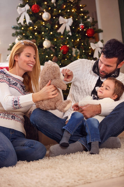 happy Christmas  family playing with bear  - Φωτογραφία, εικόνα