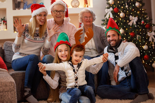 Portrait of happy family in Christmas hat - 写真・画像