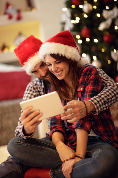 love couple Christmas pair looking on tablet - Φωτογραφία, εικόνα