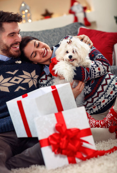 happy couple in love opening presents for Christmas - 写真・画像