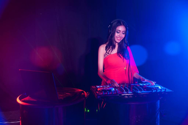 Pretty Asian female woman DJ playing music for dance. - Foto, afbeelding