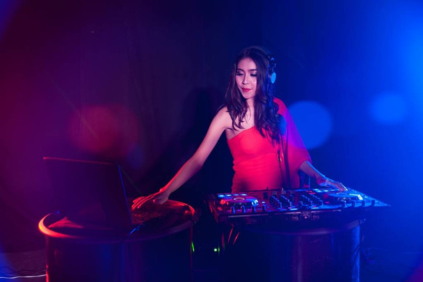 Pretty Asian female woman DJ playing music for dance. - 写真・画像