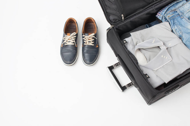 Part of the suitcase and shoes on white background - Photo, Image