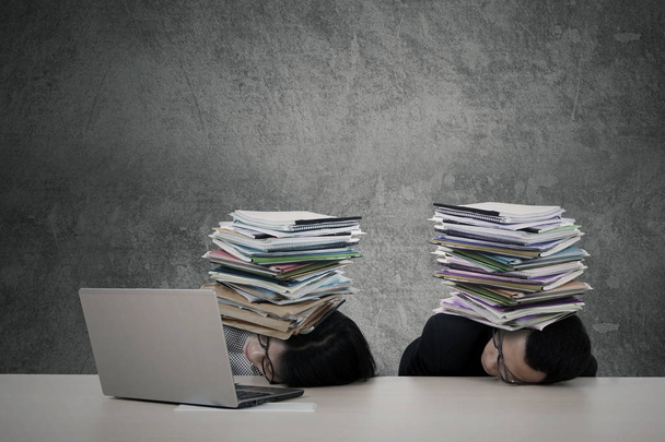 Exhausted business people sleep with documents - Photo, Image