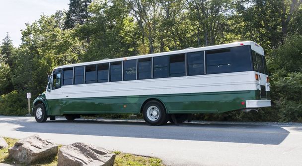 Зеленый и белый экскурсионный автобус припарковался в национальном парке Акадия
 - Фото, изображение