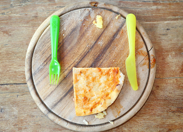 Food waste, piece of pizza remains on plate - 写真・画像