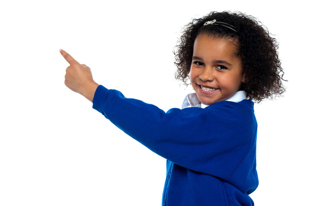 Adorable African kid pointing at copy space area - Foto, Bild