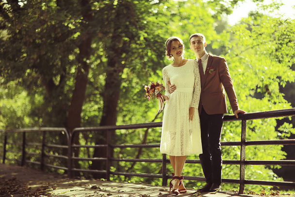 bride and groom in summer park - Φωτογραφία, εικόνα
