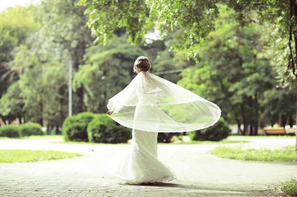 beautiful bride in summer park  - Фото, изображение