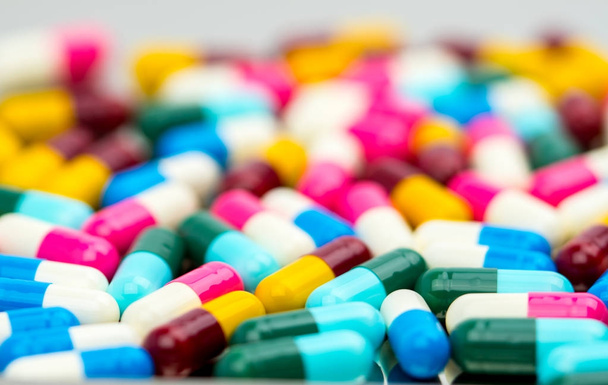Selective focus of antibiotic capsules pills on blur background, drug resistance concept. - Photo, Image