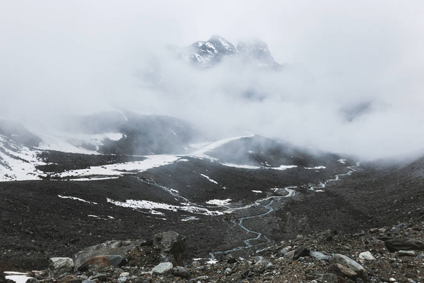 high snow peaks in clouds  - Valokuva, kuva