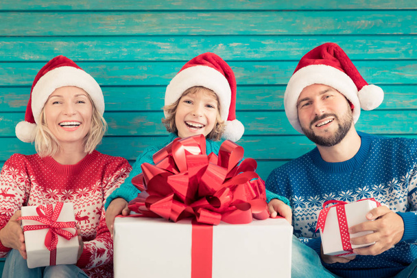 family holding Christmas gift boxes - Foto, Imagen
