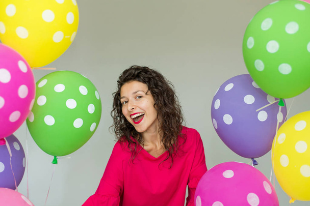 Beautiful cute cheerful girl with colored balloons. Holiday Happy Birthday - Fotografie, Obrázek