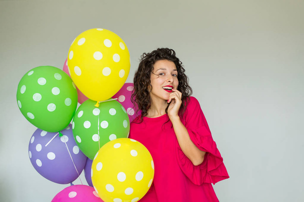 Beautiful cute cheerful girl with colored balloons. Holiday Happy Birthday - Фото, зображення