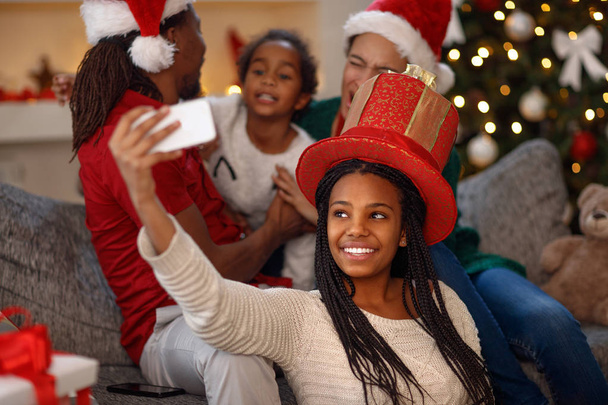 little afro American girl taking selfie on Christmas - Foto, imagen