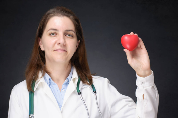 Doctor holding a red heart shape - Photo, Image