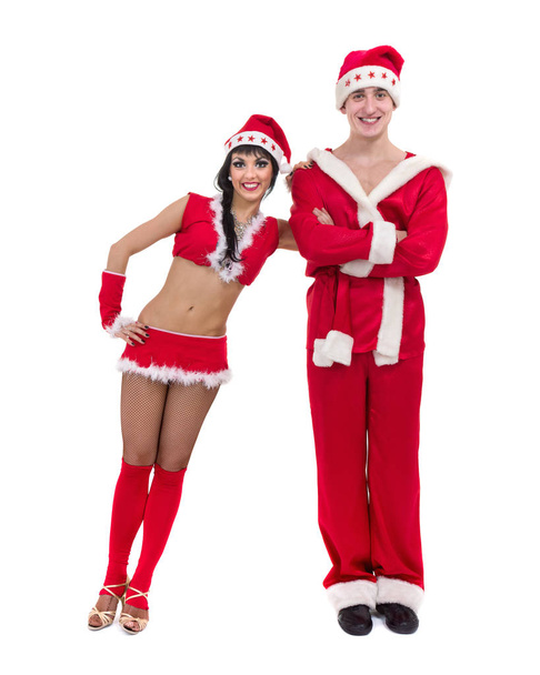 Happy young couple wearing santa claus clothes - Fotó, kép