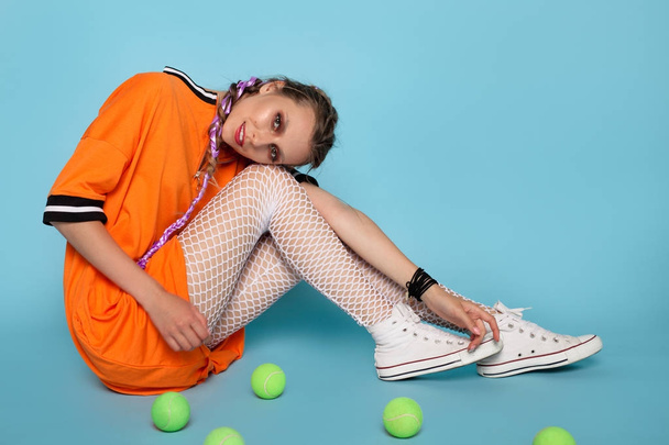 Beautiful model posing with tennis balls - 写真・画像