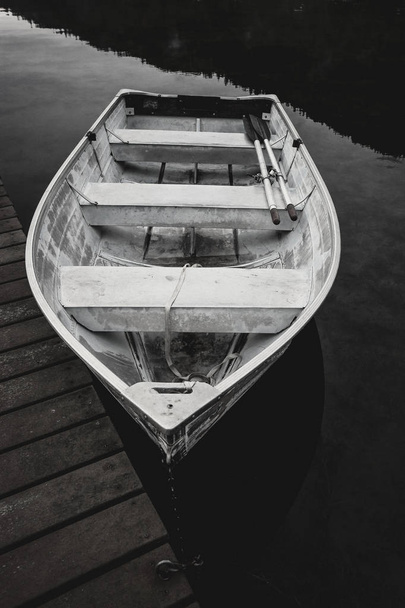 B&W of rowboat by dock. - Photo, Image