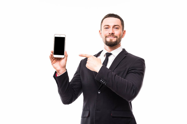 Young business man in suit pointed on screen copy space his cellphone. Full body length portrait isolated over white studio background. - Foto, immagini