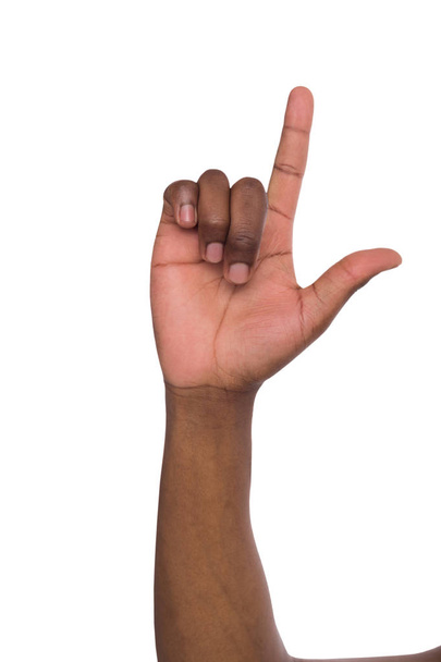 Palm of black man index finger shows up on isolated white background - Фото, изображение