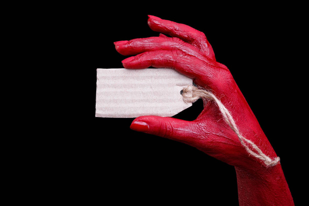 Human hands painted in red are posing on a black background. - Fotoğraf, Görsel