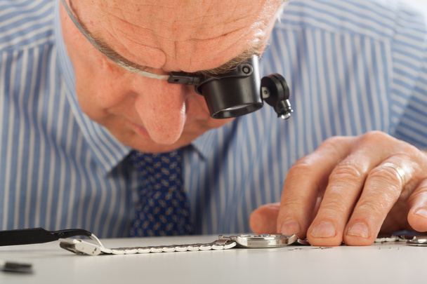Man with Magnifying Glasses Fixing Watch - Photo, Image