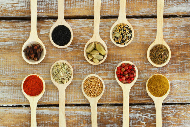 Selection of Indian spices on wooden spoons  - Fotoğraf, Görsel