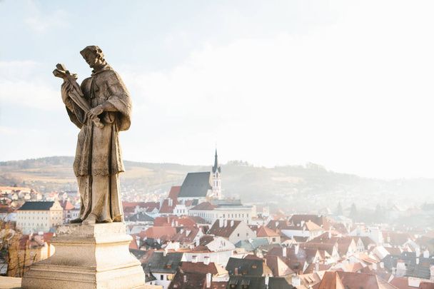 Sculptures of St. Wenceslas - the patron of the Czech Republic in the foreground, in the background view of the city of Cesky Krumlov and the Church of St. Vitus. Czech Republic, Europe. - Valokuva, kuva