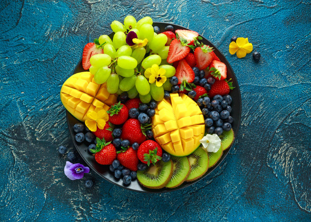 Colorful Mixed Fruit platter with Mango, Strawberry, Blueberry, Kiwi and Green Grape. Healthy food - Photo, Image