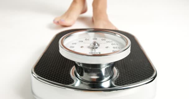 Young woman stepping on an old fashioned scale - Footage, Video