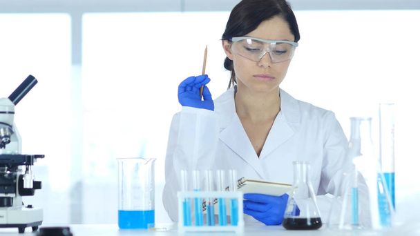Scientist in Laboratory Reading Documents, Paperwork of Result of Research - Photo, Image