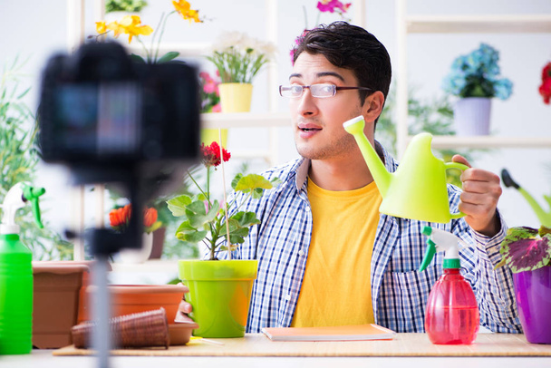 Man florist gardener vlogger blogger shooting video on camera - Photo, Image