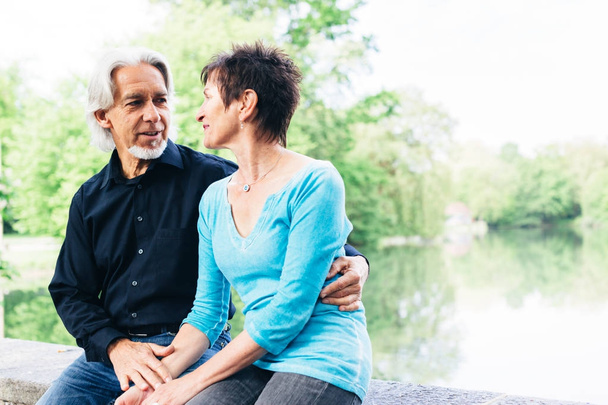 Senior Couple Relaxing By The Lake - Photo, Image