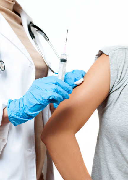Vaccination. Doctor injecting flu vaccine to patient's arm. - 写真・画像