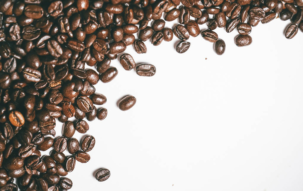 brown grains on a white background, fragrant coffee beans - 写真・画像