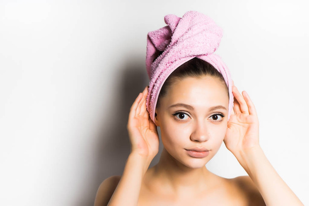 girl after shower with a pink towel on her head looking at the camera, isolated - Фото, изображение