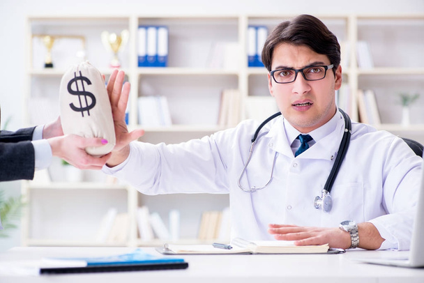 Young doctor in medical insurance fraud concept - Foto, Imagem