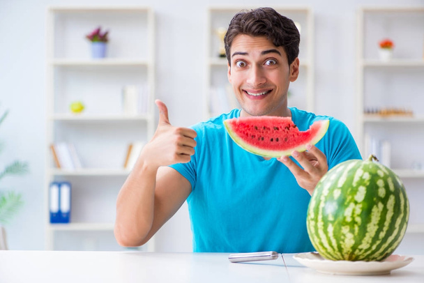 Man eating watermelon at home - Photo, Image