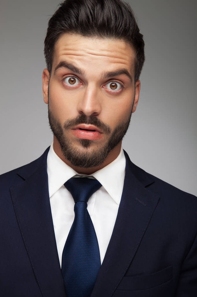 businessman making big eyes because he is amazed and shocked  - Foto, afbeelding