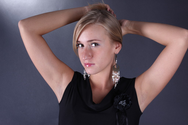 Portrait of the beautiful blonde on a black background - Photo, image