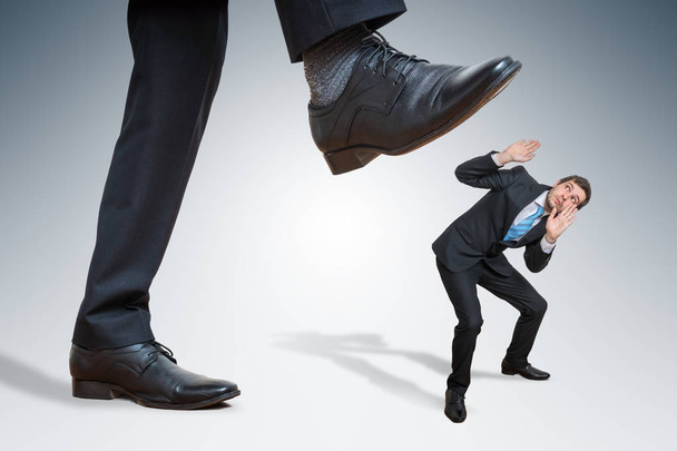 Angry big businessman is abusing small employee. - Photo, Image