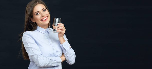 Smiling womanwith long hair holding water glass.  - 写真・画像