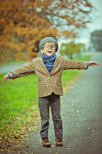 Cute stylish boy in warm clothes in autumn scenery - Foto, immagini