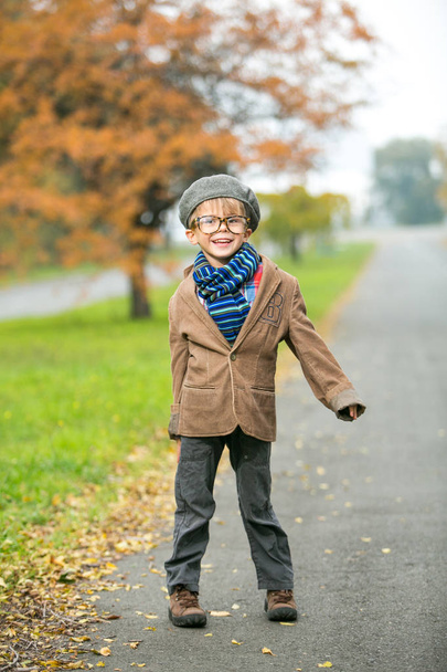 Cute stylish boy in warm clothes in autumn scenery - Φωτογραφία, εικόνα