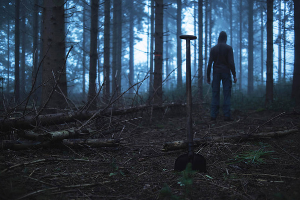 Shovel and man in misty forest - Photo, Image